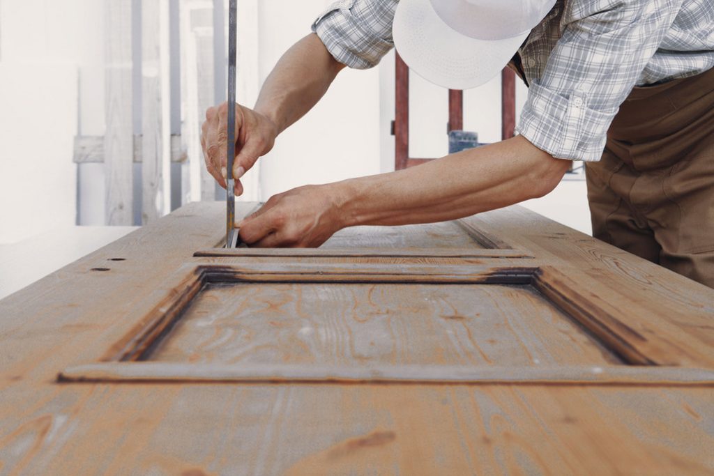 Carpenter doing measurements on the door