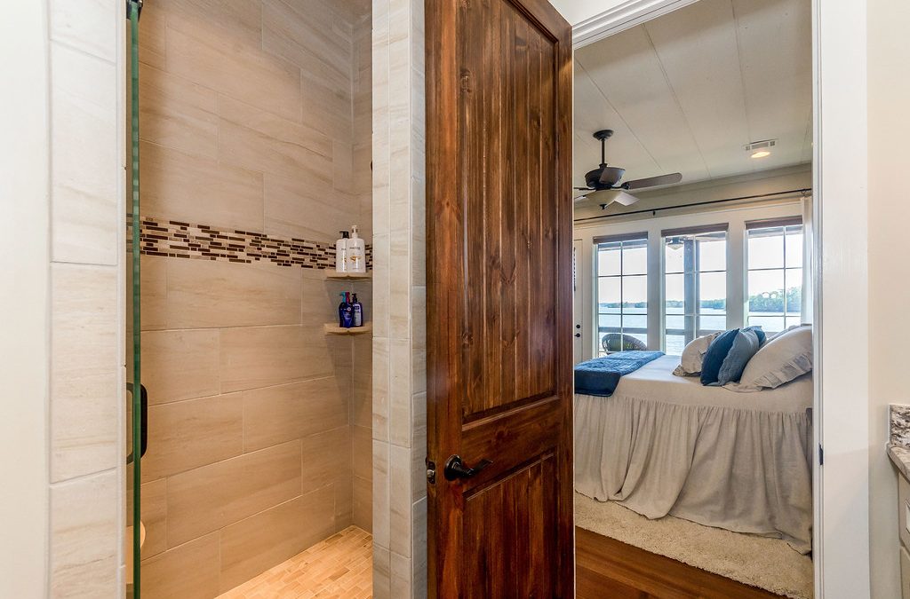 opened wooden door leading from bathroom to master bedroom